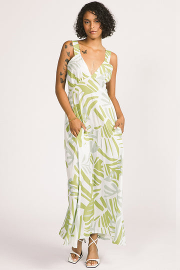 Woman wearing green and white leaf print Alora maxi dress by Allison Wonderland. 