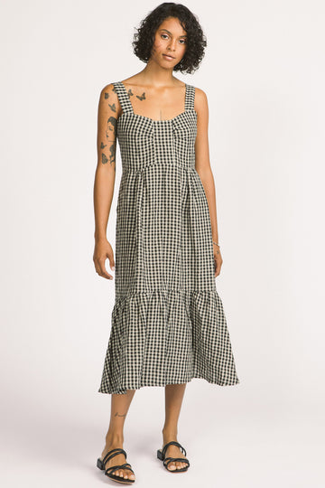 Woman wearing black and white linen gingham tiered Calista summer dress by Allison Wonderland. 