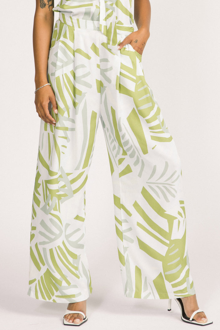Women wearing green and white frond leaf print Darcy pants by Allison Wonderland. 