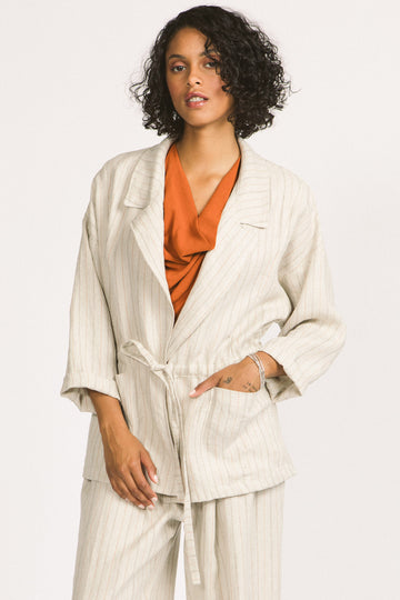 Woman wearing ivory stripe linen drawstring Greer blazer by Allison Wonderland. 