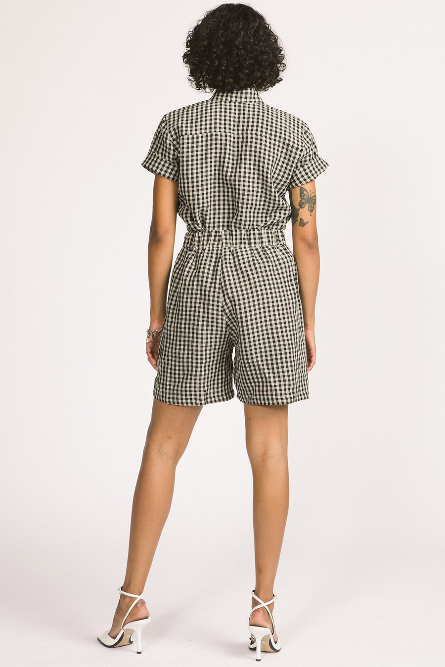 Back view of woman wearing black and white gingham Kim shorts by Allison Wonderland. 