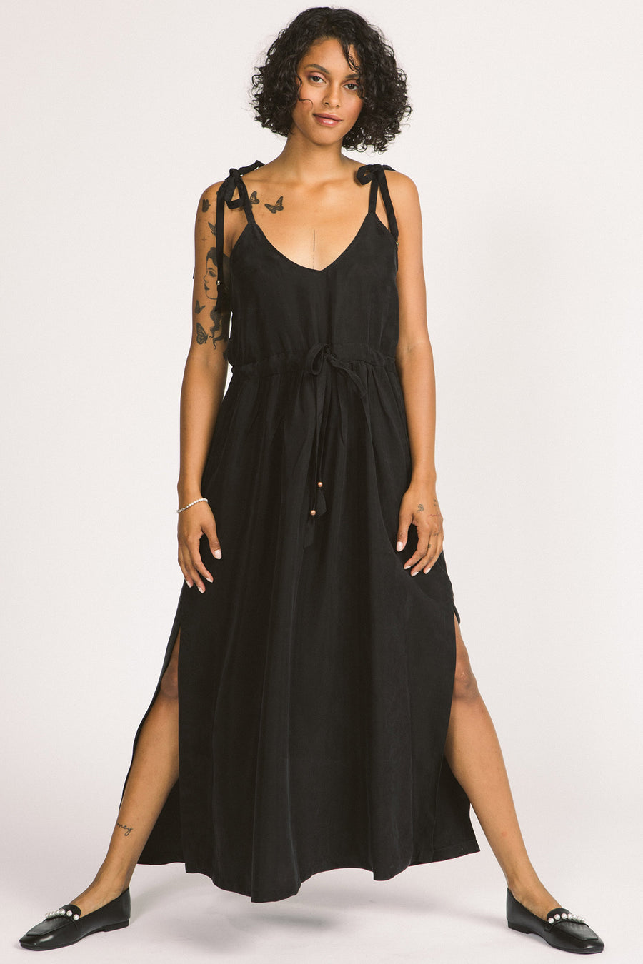 Woman wearing black Novalie dress by Allison Wonderland with adjustable shoulder straps and waist. 