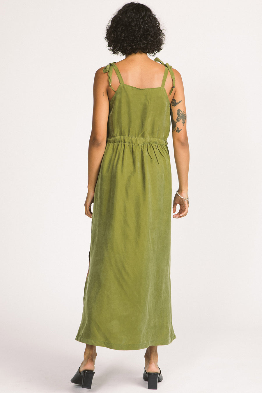 Back view of woman wearing moss green Novalie dress by Allison Wonderland with adjustable shoulder straps and waist. 