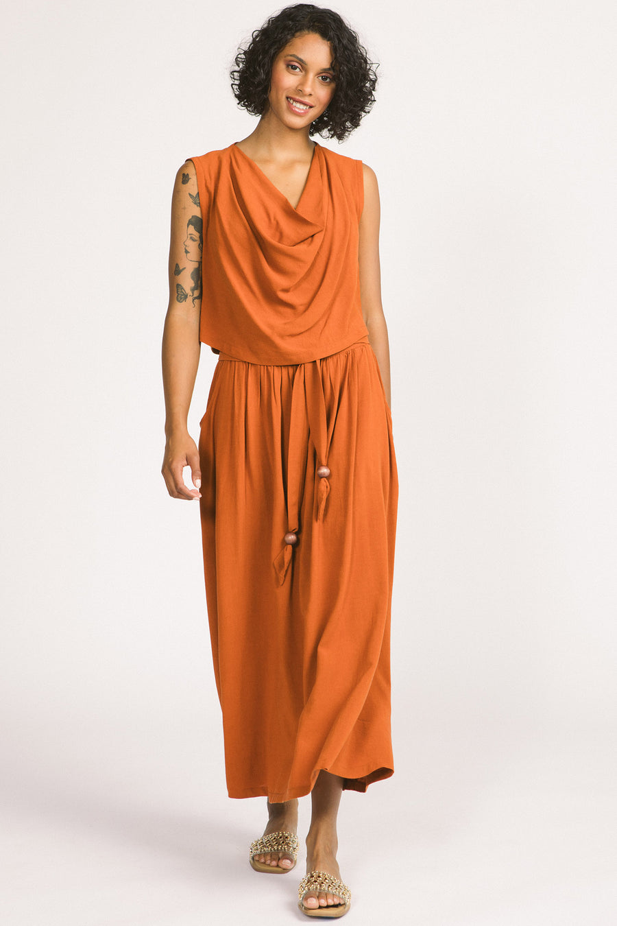 Woman wearing orange cognac Oriana maxi skirt by Allison Wonderland. 