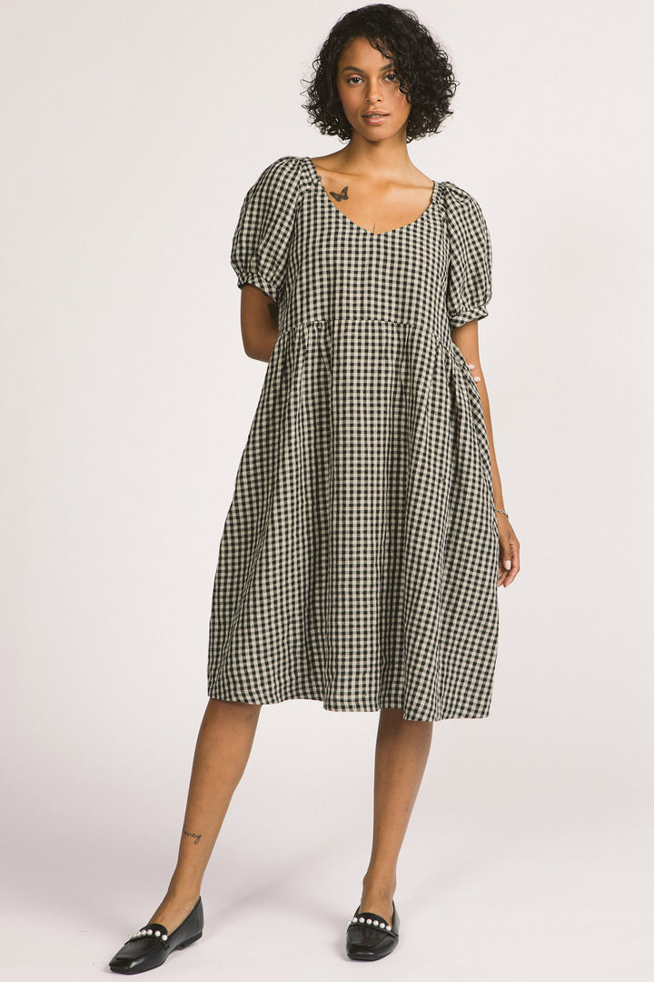 Woman wearing black and white linen gingham oversized babydoll Verity dress. 