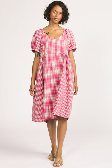 Woman wearing pink and white linen gingham oversized babydoll Verity dress. 