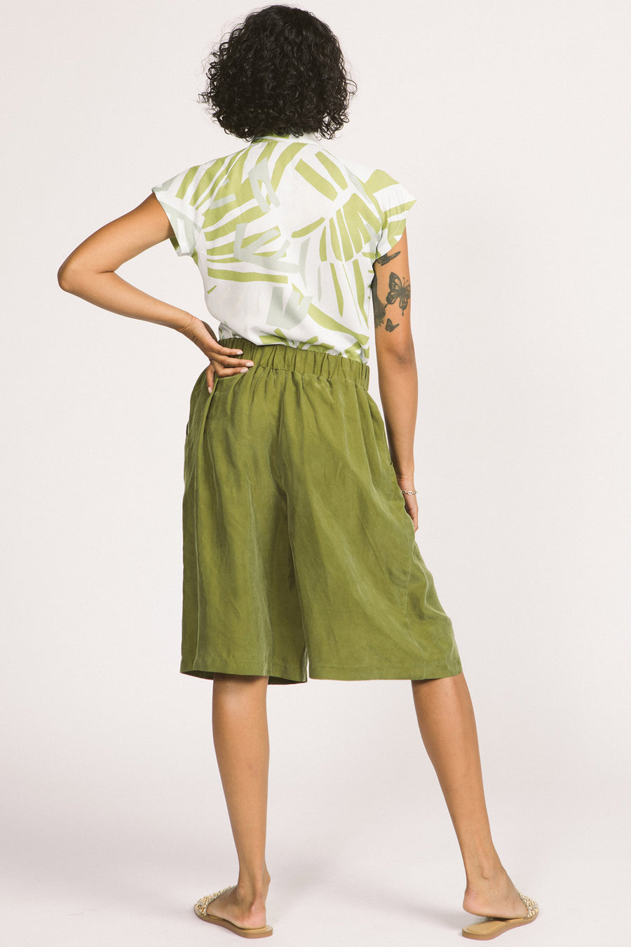 Back view of woman wearing moss green culotte Yara shorts by Allison Wonderland. 