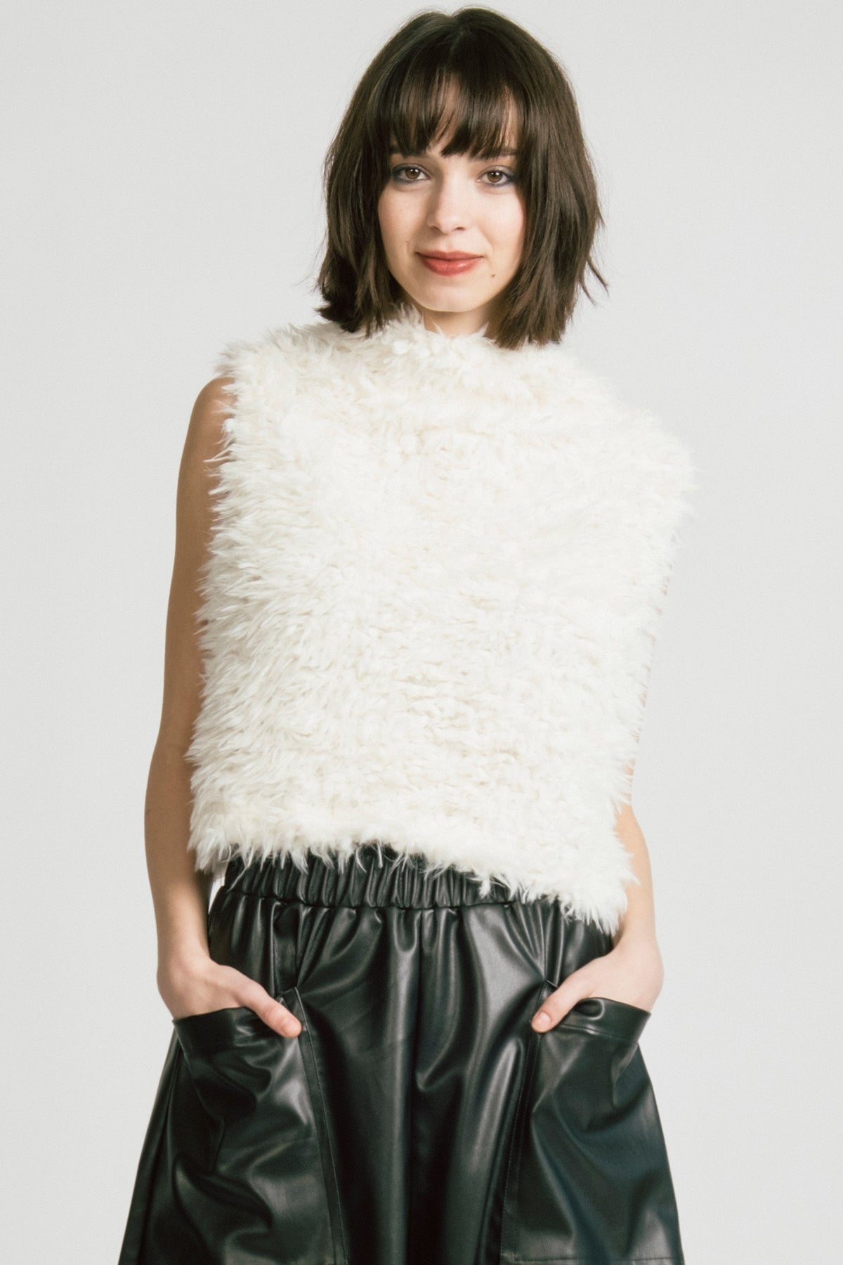 Woman wearing white feathered tank top