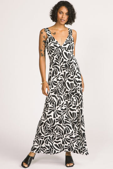 Woman wearing black and white leaf print Alora maxi dress by Allison Wonderland. 
