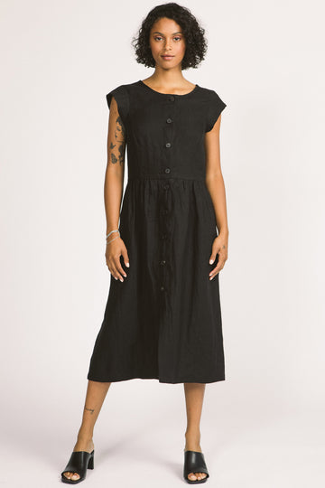 Woman wearing black button up linen midi Blythe dress by Allison Wonderland. 