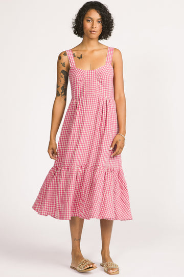 Woman wearing pink and white linen gingham tiered Calista summer dress by Allison Wonderland. 