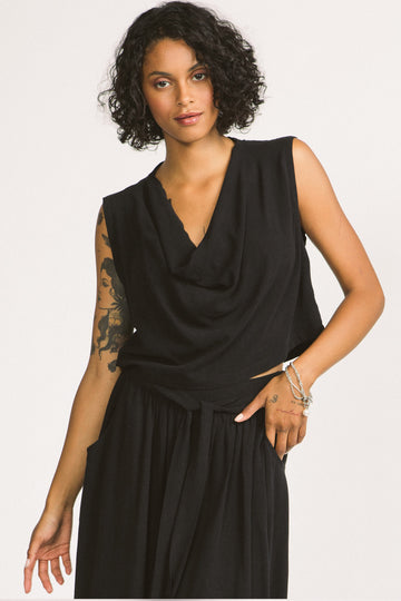 Woman wearing black cowl neck sleeveless Kiko blouse by Allison Wonderland. 