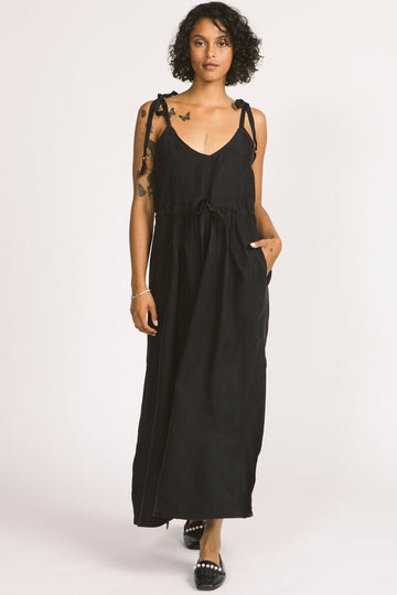 Woman wearing black Novalie dress by Allison Wonderland with adjustable shoulder straps and waist. 