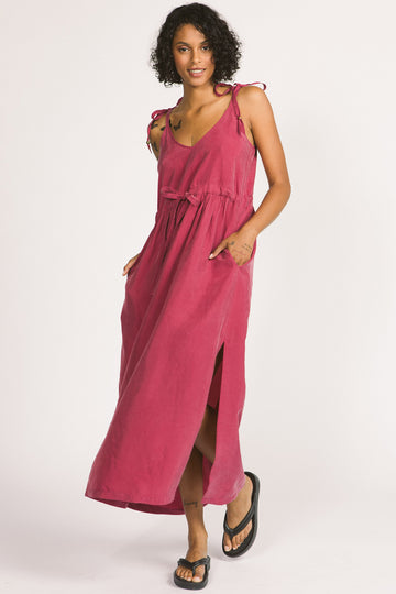 Woman wearing magenta pink Novalie dress by Allison Wonderland with adjustable shoulder straps and waist. 