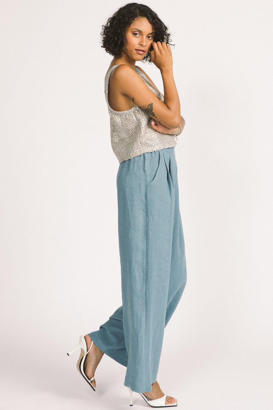 Side view of woman wearing sky blue linen wide leg Romy pants by Allison Wonderland. 