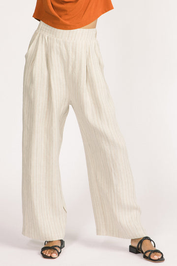 Woman wearing ivory stripe linen wide leg Romy pants by Allison Wonderland. 