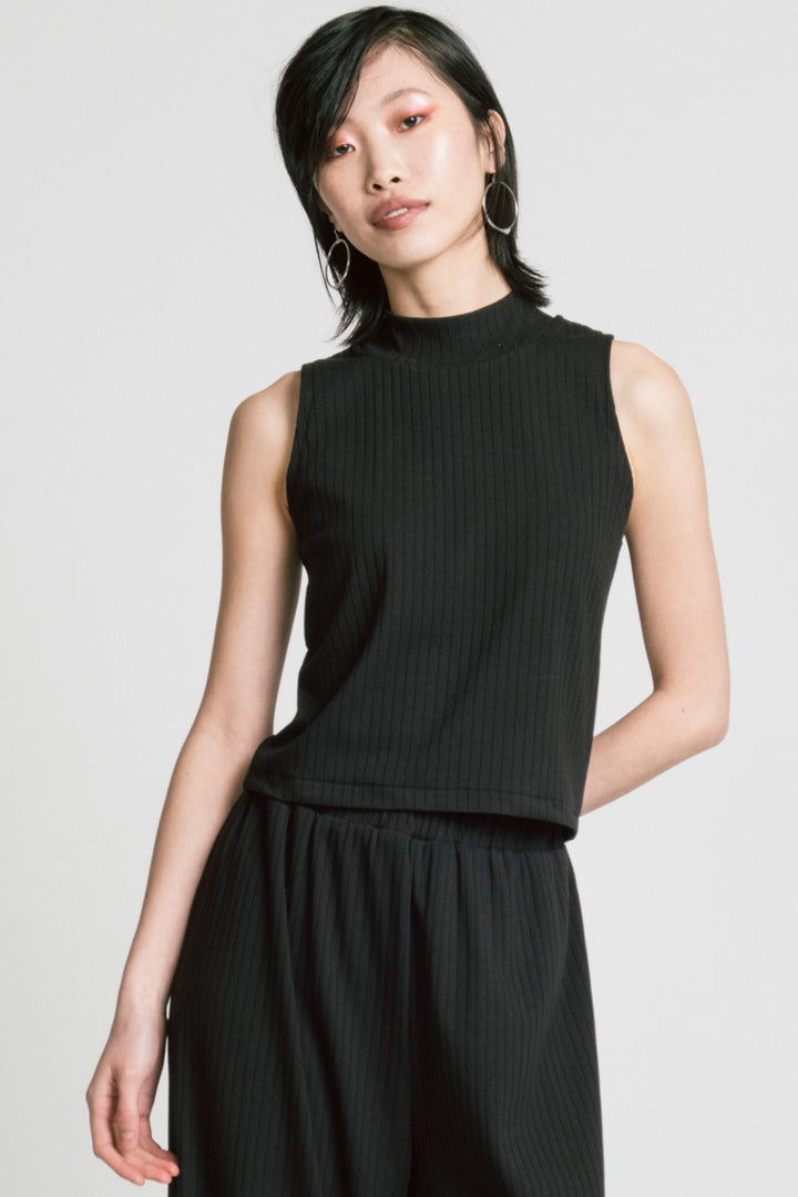 Model wearing Trigger Top in black by Allison Wonderland.