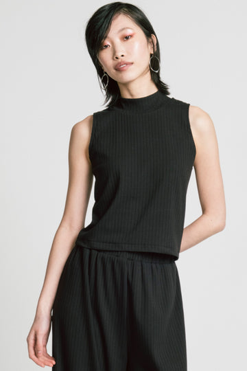 Model wearing Trigger Top in black by Allison Wonderland.