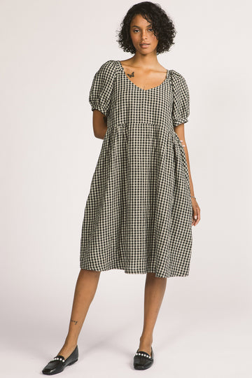 Woman wearing black and white linen gingham oversized babydoll Verity dress. 
