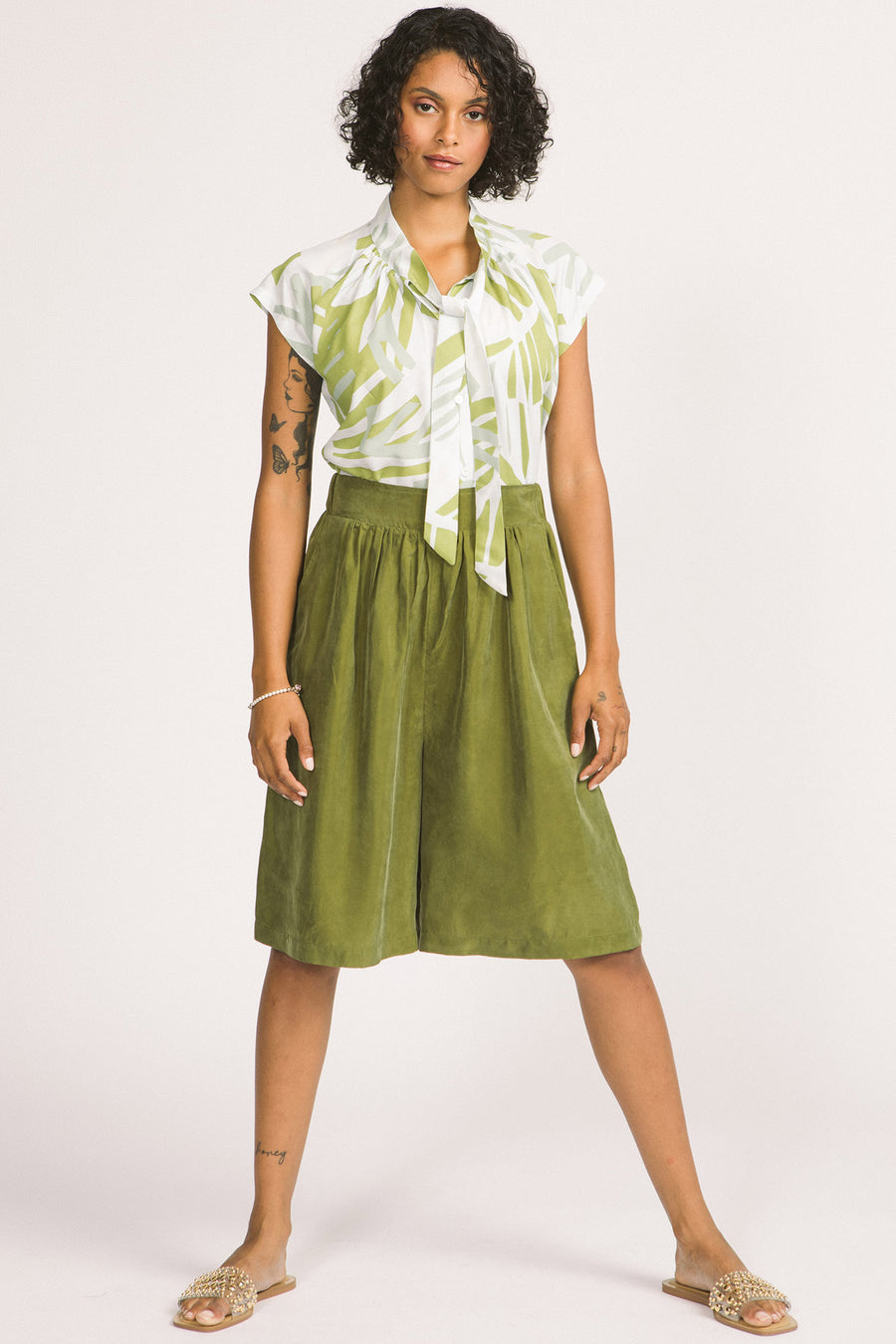 Woman wearing moss green culotte Yara shorts by Allison Wonderland. 