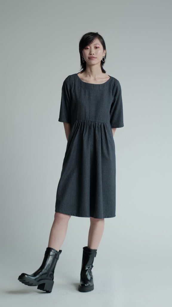 Video of model in studio wearing denim pinstripe Period Dress.