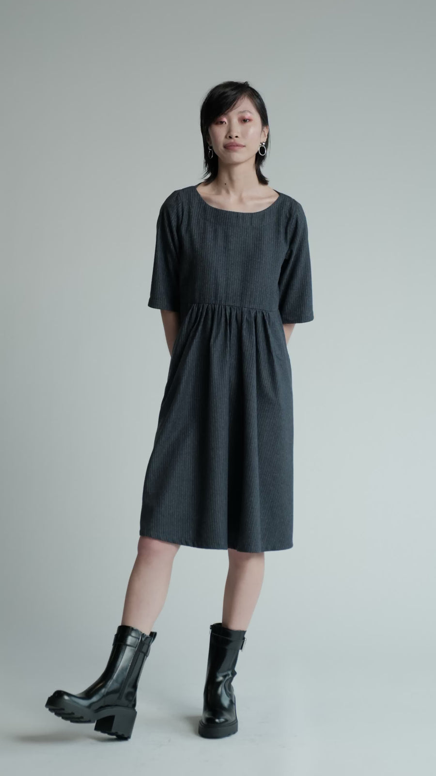 Video of model in studio wearing denim pinstripe Period Dress.