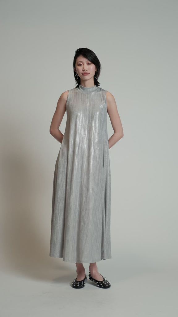 Video of a model in a studio wearing a silver Swing Dress.