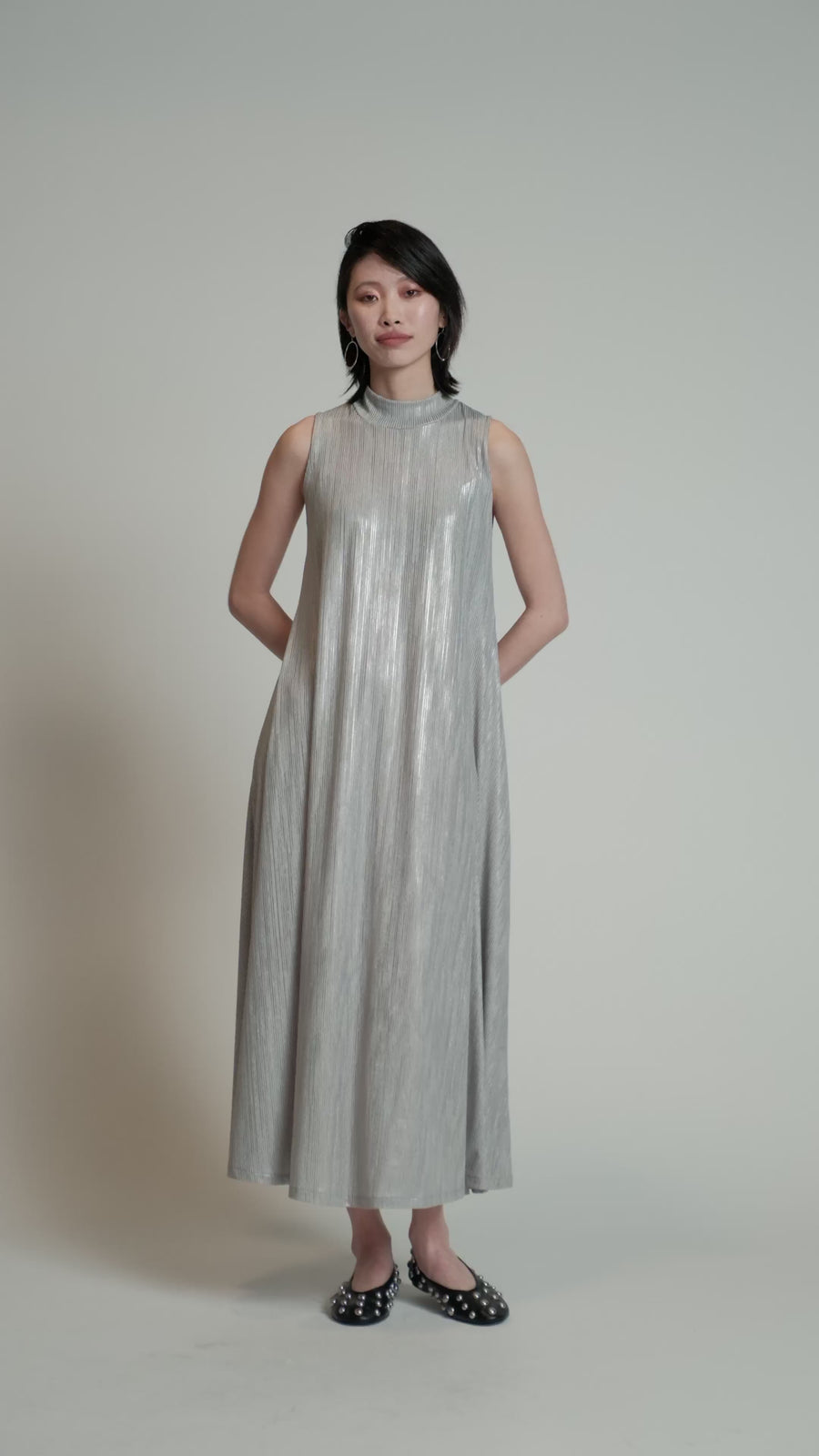 Video of a model in a studio wearing a silver Swing Dress.