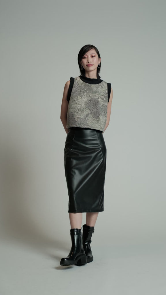 Video of a model in a studio wearing a houndstooth Peri Vest.