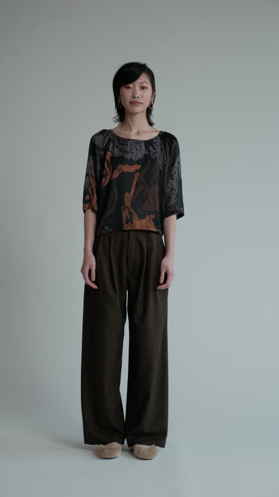 Video of a model in a studio wearing a horse print Flash Blouse.