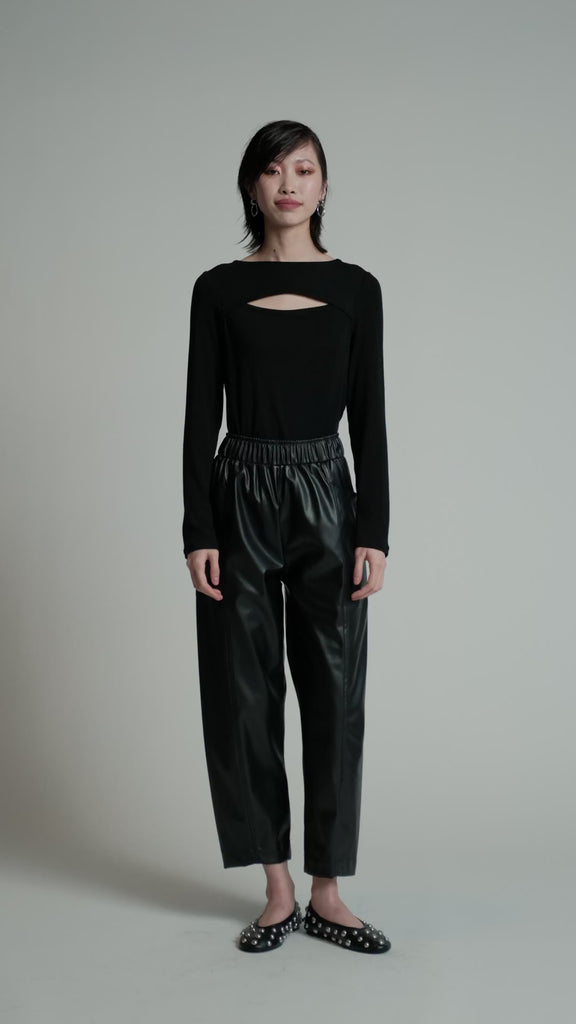 A video of a model in a studio wearing a black Insomnia sweater.