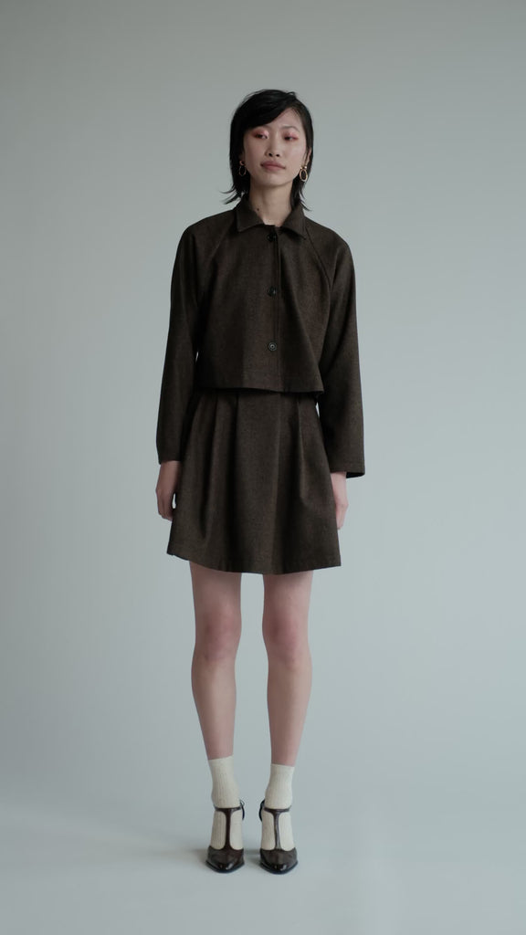 Video of model in studio wearing brown herringbone Trouble Skirt.