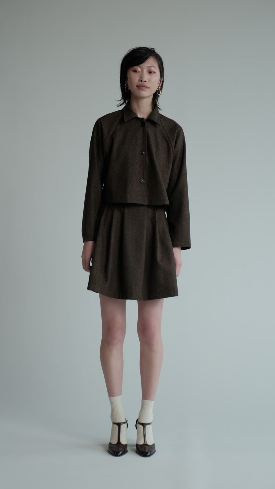 Video of model in studio wearing brown herringbone Trouble Skirt.