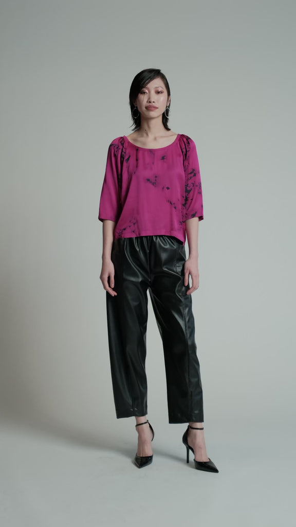 Video of a model in a studio wearing a pink Flash Blouse.