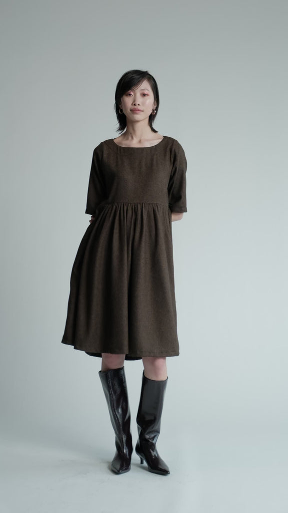 Video of model in studio wearing brown herringbone Period Dress.