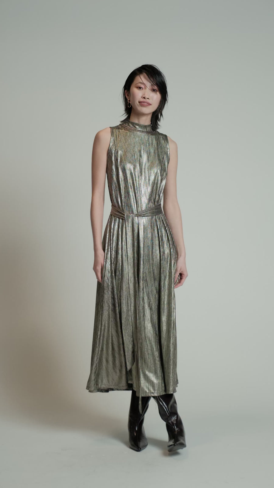 Video of a model in a studio wearing a gold Swing Dress.