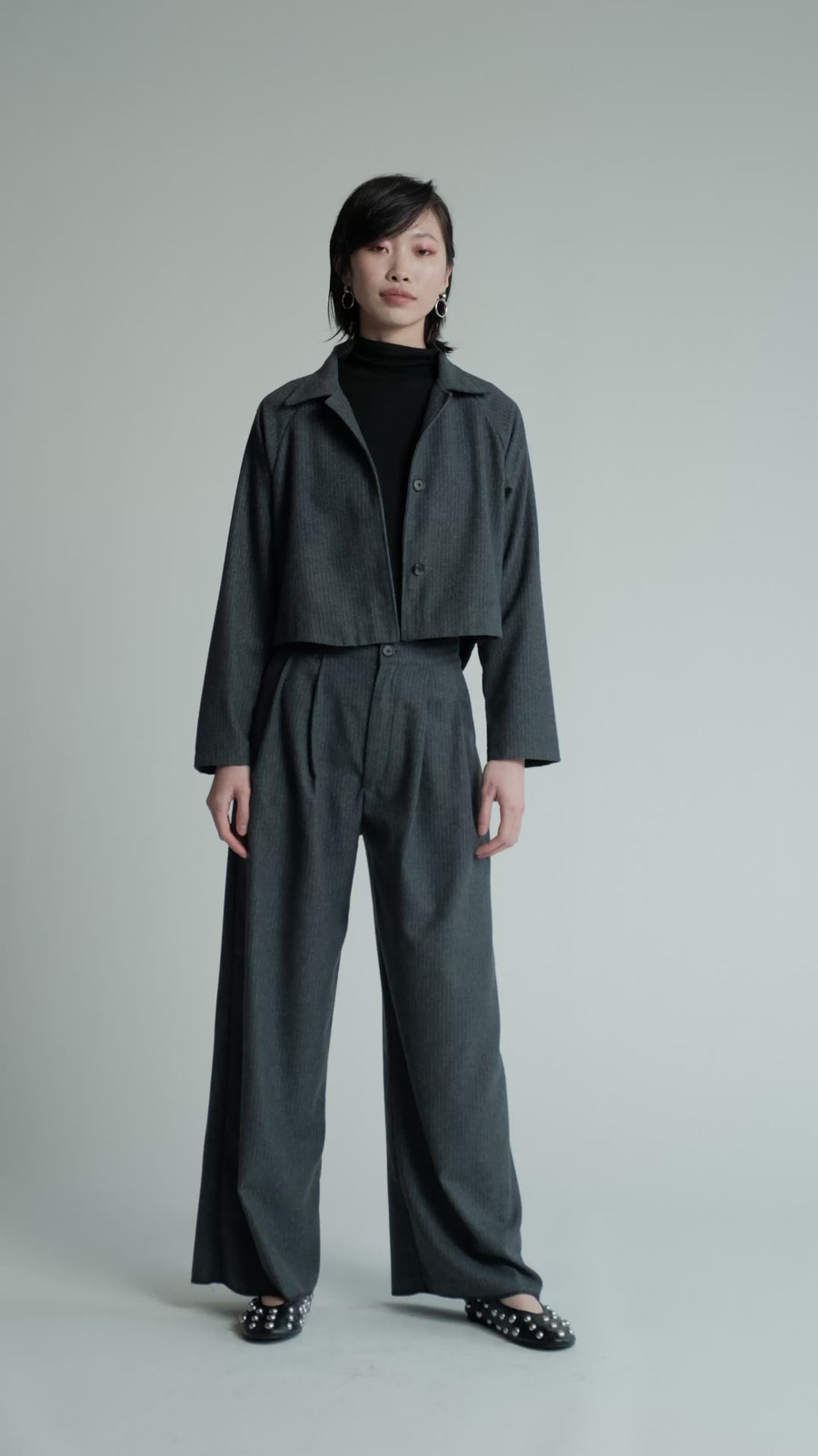 Video of model in studio wearing denim pinstripe Cycle Jacket.